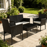 Patio Furniture Set 4 Piece PE Rattan with soft cushions and glass table in an outdoor garden setting.