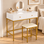 White and gold dressing table set styled with makeup in a modern bedroom