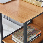 Close-up of Computer Desk Student Table with open shelves displaying books and decorative items, showcasing a tidy workspace.