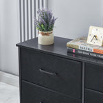 Black dresser with a plant, books, and clock on top against a gray wall. | Artisansa SA