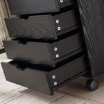 Black Bedside Table with Drawers featuring multiple open drawers for convenient storage solutions.
