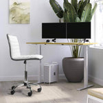 Adjustable bar stool set in a modern workspace with dual monitors and potted plant backdrop.