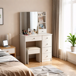 Compact white vanity table and stool beside a bed in a bright bedroom