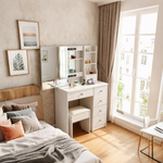 Space-saving white dressing table and stool beside a bed and window