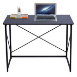 Minimalist Computer Desk with X-Frame Design featuring a sleek surface and laptop for home office setup.