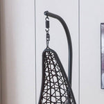 Black woven hammock swing chair F95 against a light gray wall | Artisansa SA
