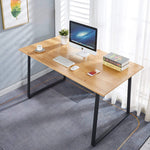 150cm office desk workstation with large desktop, monitor, keyboard, and books in a bright room.