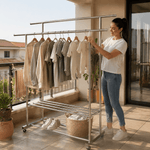 Double Rail Clothes Rack with Shoe Shelf displaying neatly hung clothes on a balcony with a woman organizing them.