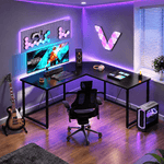 Modern black corner computer desk with raised monitor shelf and spacious workspace