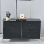 Black dresser with decorative items on a gray wall background | Artisansa SA