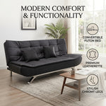 Convertible black PU leather sofa bed with tufted cushioning and chrome legs
