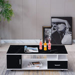 Modern black and white coffee table with drinks and a magazine in a living room setting. | Artisansa SA