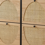 Close-up of a light oak wood cabinet with four arched cane or rattan panel doors and small round black knobs.