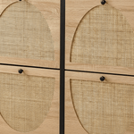 Close-up of a light oak wood cabinet with four arched cane or rattan panel doors and small round black knobs.