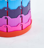 Colourful plastic toy structure with blue, purple, and red segments - retractable telescopic foot stool KJ-01 component | Artisansa SA