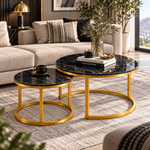 Black marble-look nesting coffee tables with gold frames in an elegant living room