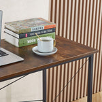 Detail view of books and coffee on teak wood computer desk