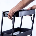 Person adjusting the top of a 3-Tier Storage Cart with a durable iron frame, ideal for organization and space-saving.