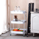 3-Tier Storage Cart with white baskets displaying kitchen items and colorful fruits on a grey floor.