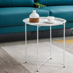 Stylish steel side table set in modern design with a white tray, plant, and cup, perfect for contemporary interiors.