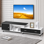 Black and white TV console arranged beneath a wall-mounted television in a modern lounge