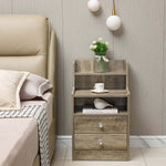 White Bedside Table with Drawers set next to a bed, featuring two drawers and an open shelf for decor.