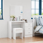 Side angle view of a White Dressing Table with Mirror and matching stool positioned near a window