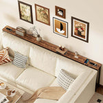 Narrow Sofa Table with Charging Station displayed behind a light-colored sofa with decorative pillows and wall art.