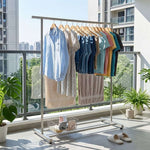 Double Rail Retractable Clothes Rack with Wheels displaying neatly hung clothes on a balcony.