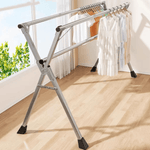 Foldable Clothes Rail with stainless steel X-frame holding various garments in a well-lit room.
