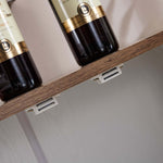 Details of the shelf supports on the farmhouse sideboard storage cabinet with bottles on top.