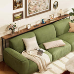 Narrow Sofa Table with Charging Station displayed behind a green sofa in a cozy living room setting.