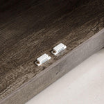 Close-up of farmhouse sideboard storage cabinet hardware connections on a rustic brown finish.