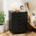 Black Bedside Table with Drawers (5-Tier) next to a lamp and clock, providing stylish storage solutions.