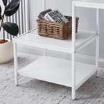 Close-up of white multi-tier storage shelves for computer desk organization