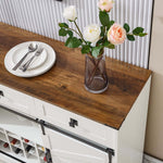 Farmhouse Wine Bar Cabinet with rustic wood top, white finish, decorative flowers, and dining plates.