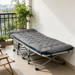 Portable folding camping cot with mattress used for relaxing on home balcony