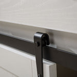 Close-up of farmhouse wine bar cabinet sliding door hardware, showcasing metal track and rustic white wood.