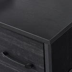 Close-up of the wood top of the Fabric 8-Drawer Dresser, showcasing its sleek black design and durable finish.