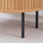 Sturdy black metal legs on round side table with storage