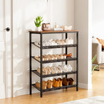 5 tier shoe rack by a doorway with trainers and boots on mesh shelves and a plant on the rustic top