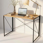 Burningwood folding office desk styled with laptop, books and lamp