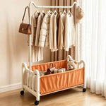 Steel Clothing Rack with Shelves & Wheels displaying hanging clothes and storage for toys and bags.