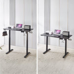 Electric Standing Desk in black, adjustable height with laptop and speaker, ideal for ergonomic workspace.