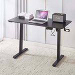 Electric Standing Desk Black Adjustable 120cm with laptop and speaker on top, ideal for ergonomic workspaces.