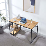 Light wood computer desk with reversible shelves in a bright home office beside a window