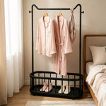 Freestanding Clothes Rack displaying pink pajama set and robe with shoes on an open bottom shelf in a cozy bedroom.