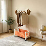 Steel Clothing Rack displaying clothes and accessories, featuring a fabric shelf and wheels, ideal for space-saving.