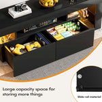 Open drawers on black TV stand displaying controllers, games and media accessories