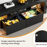 Open drawers on black TV stand displaying controllers, games and media accessories